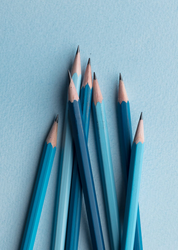 Blue pencils on a blue background.
