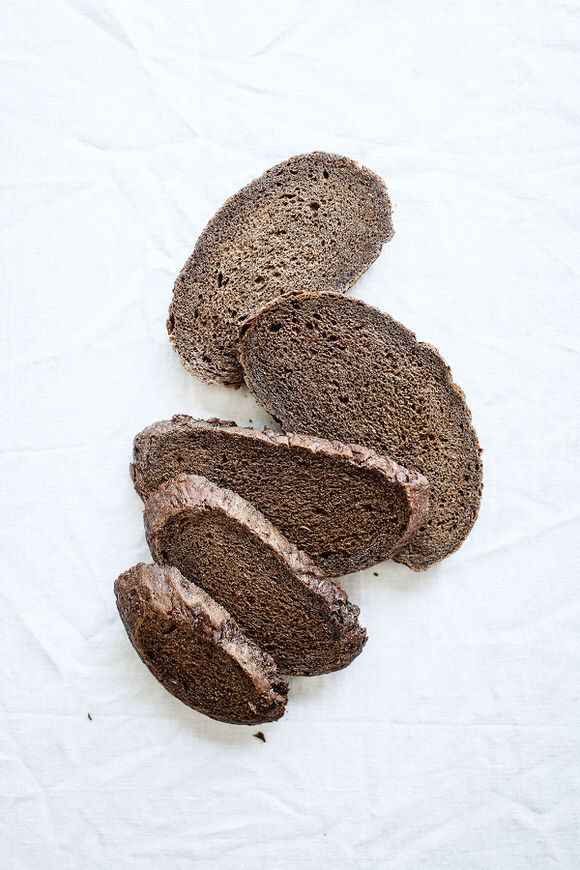 Image of rye bread on white table.