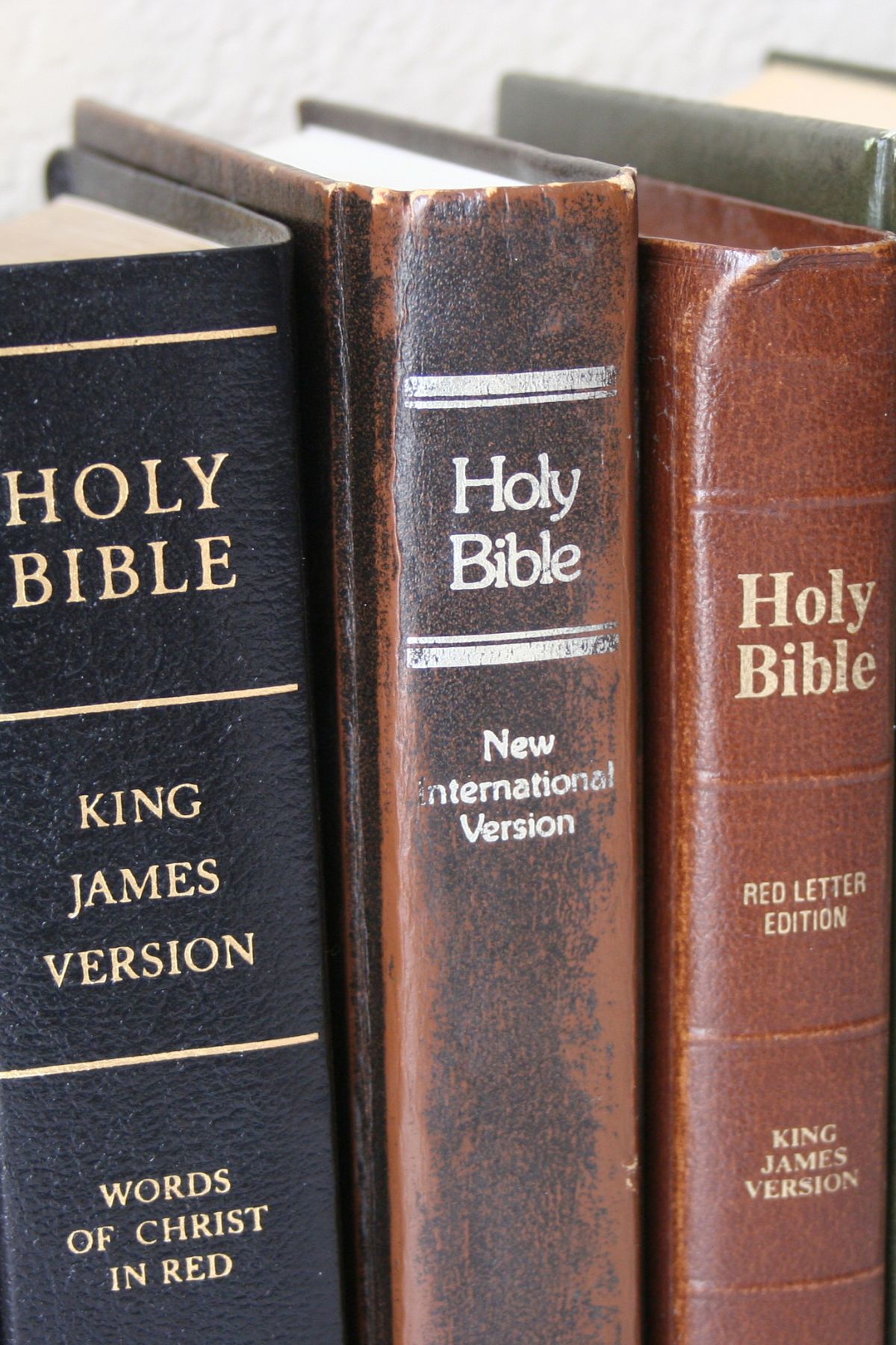 Different Bible translations on a shelf